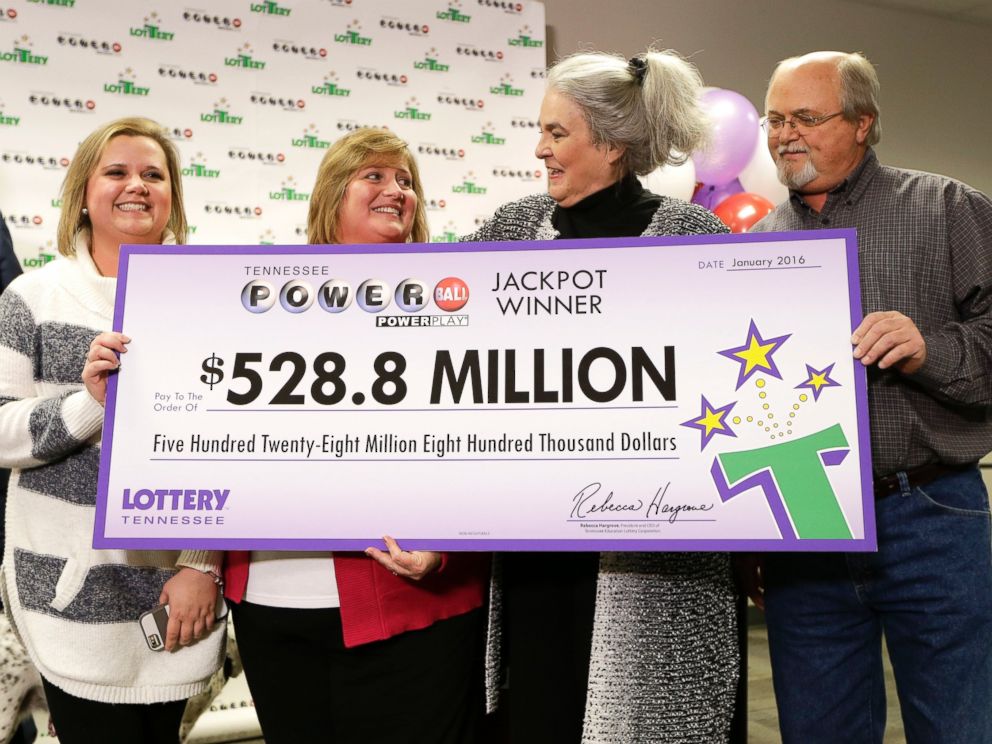 PHOTO: Rebecca Hargrove, second from right, president and CEO of the Tennessee Lottery, presents a ceremonial check to John Robinson, right; his wife, Lisa, second from left; and their daughter, Tiffany, left; on Jan. 15, 2016, in Nashville, Tenn.