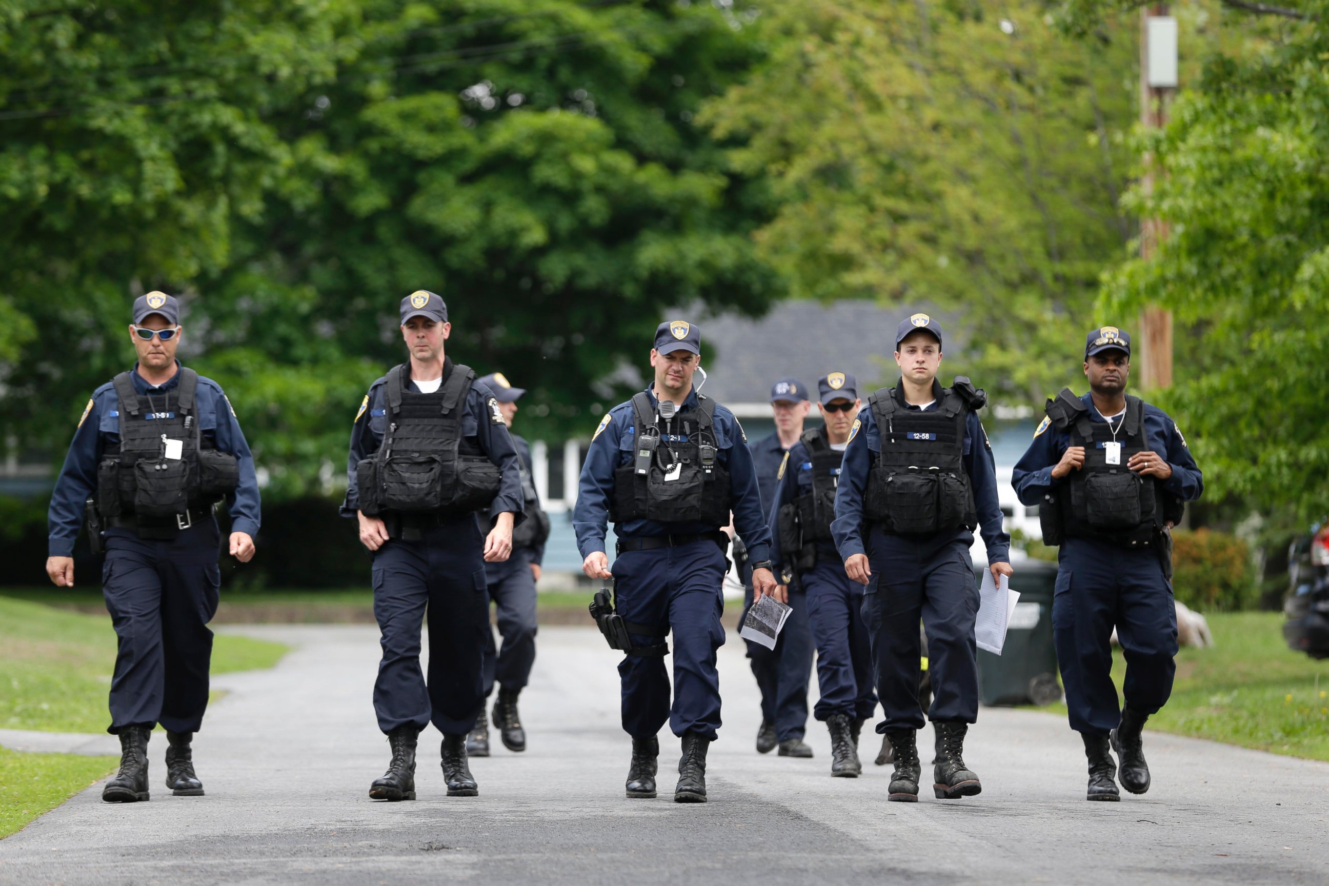 PHOTO: Law enforcement officers walk the streets in Dannemora, N.Y., as they searched houses near the maximum-security prison in northern New York where two killers escaped using power tools, June 10, 2015.
