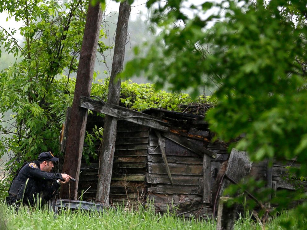 PHOTO: A law enforcement officer checks a broken down building for escaped prisoners near Essex, N.Y., June 9, 2015.