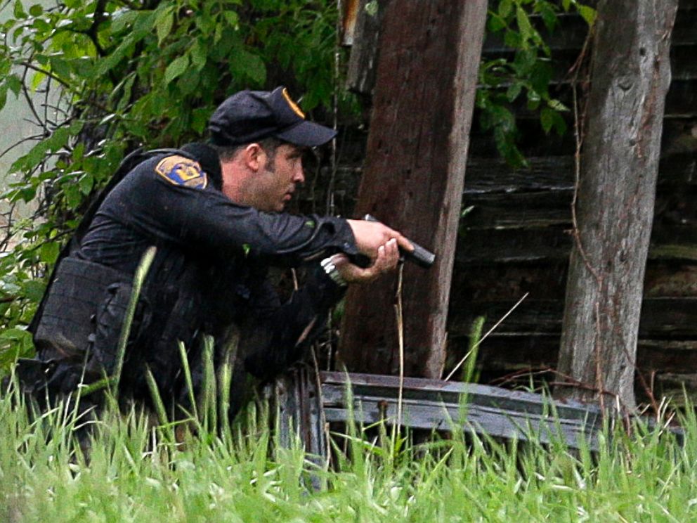 PHOTO: A law enforcement officer checks a broken down building for escaped prisoners near Essex, N.Y., June 9, 2015.