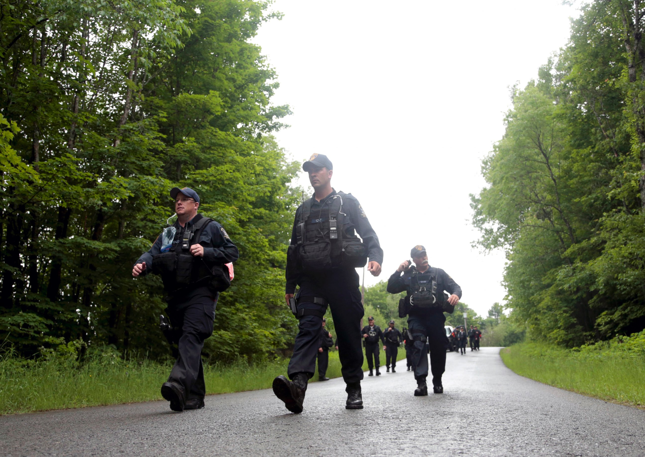 PHOTO: Corrections officers walk along a road after leaving a wooded area while searching for two prison escapees from Clinton Correctional Facility in Dannemora, June 23, 2015, in Owls Head, N.Y.