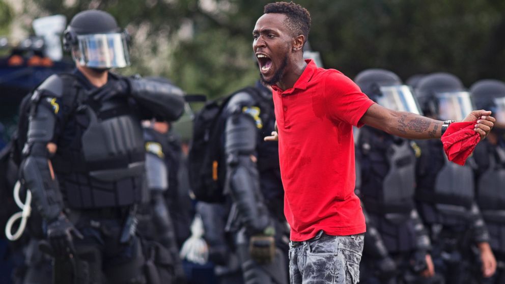 PHOTO: A protester yells at police in front of the Baton Rouge Police Department headquarters after police arrived in riot gear to clear protesters from the street in Baton Rouge, Louisiana, July 9, 2016.