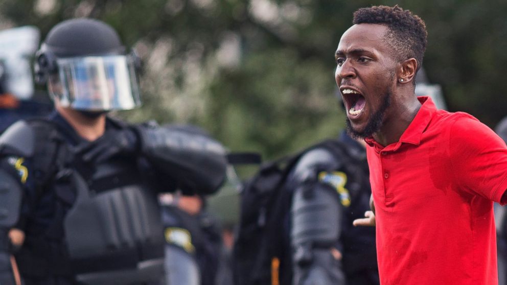 PHOTO: A protester yells at police in front of the Baton Rouge Police Department headquarters after police arrived in riot gear to clear protesters from the street in Baton Rouge, Louisiana, July 9, 2016.