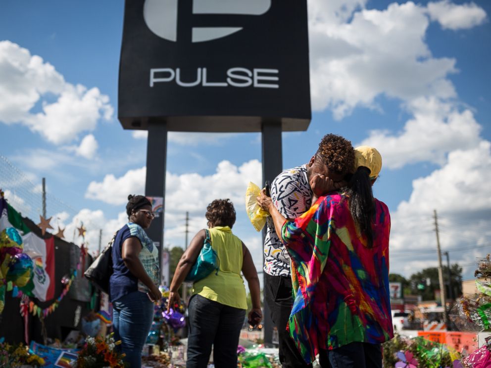 PHOTO: Wayne Dominici, 23, cries on the shoulder of his aunt, Ada Dominici, July 12, 2016, at a memorial outside Pulse, the gay nightclub where a shooter killed 49 people in Orlando, Florida.