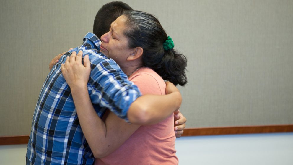 Steve Hernandez wipes a tear from his mother's eye after seeing her for the first time in 20 years in San Diego, June 9, 2016.