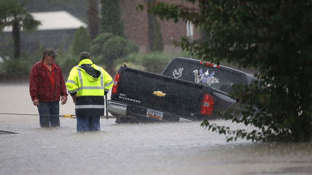 PHOTO: A tow-truck operator assists a stranded motorist during flash flooding in Florence, S.C.,  Oct. 4, 2015, as heavy rain continues to cause widespread flooding in the state.