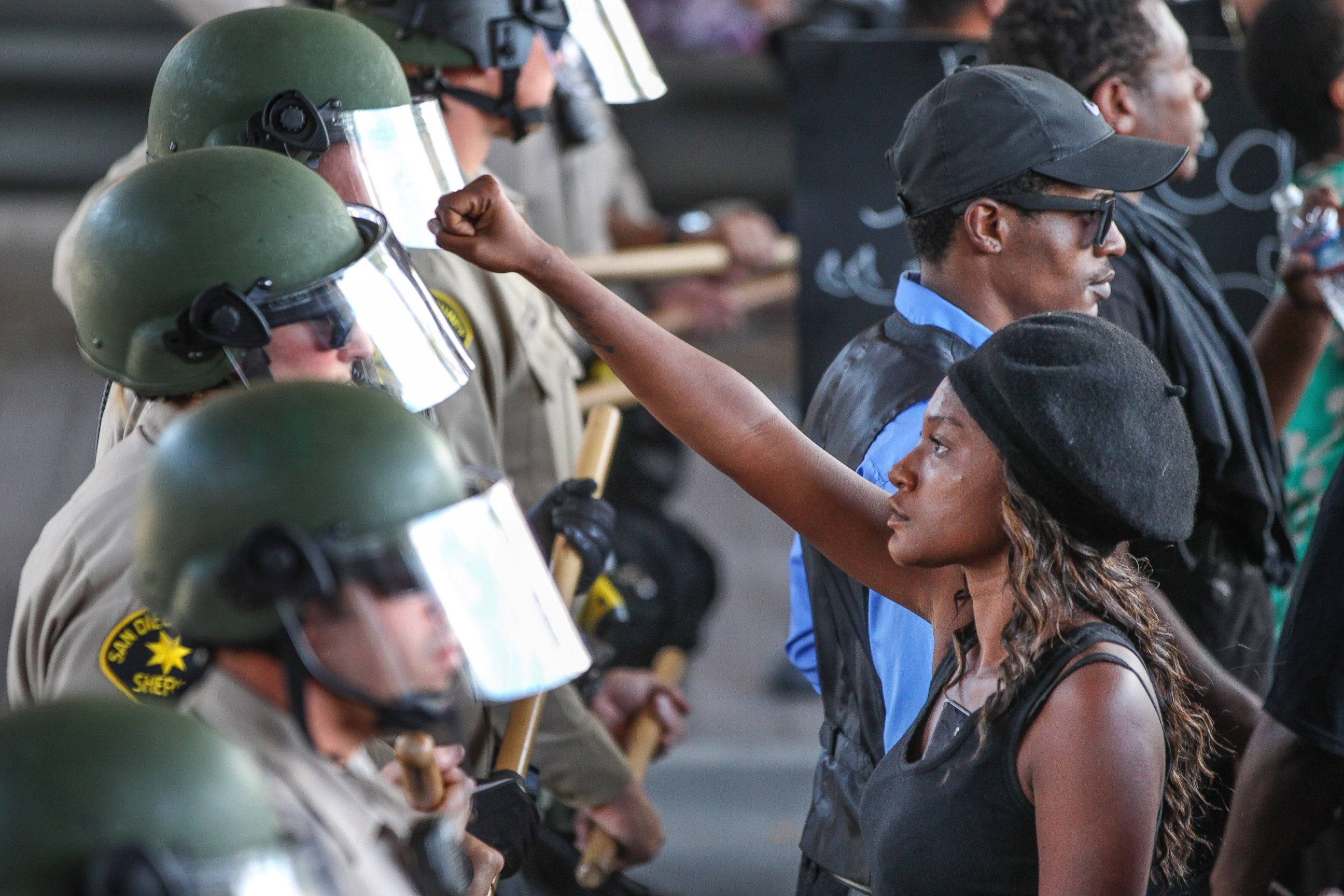 PHOTO: Ebonay Lee holds up her fist toward a line of Sheriff's deputies, Sept. 28, 2016, in El Cajon, California. Demonstrators protested the killing of a black man shot by an officer after authorities said the man pulled an object from a pocket.