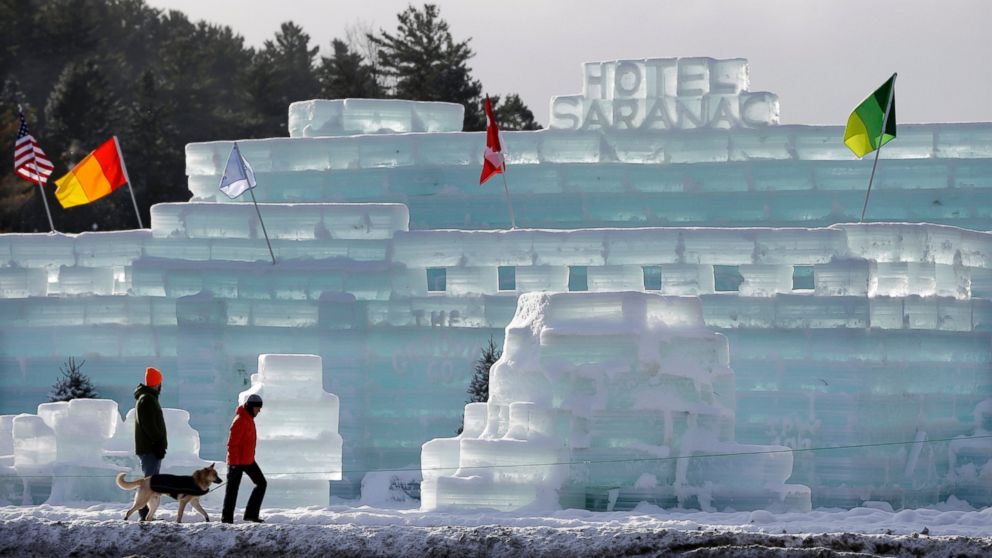 People pass by the Hotel Saranac ice palace in Saranac Lake, N.Y., Feb. 1, 2015.