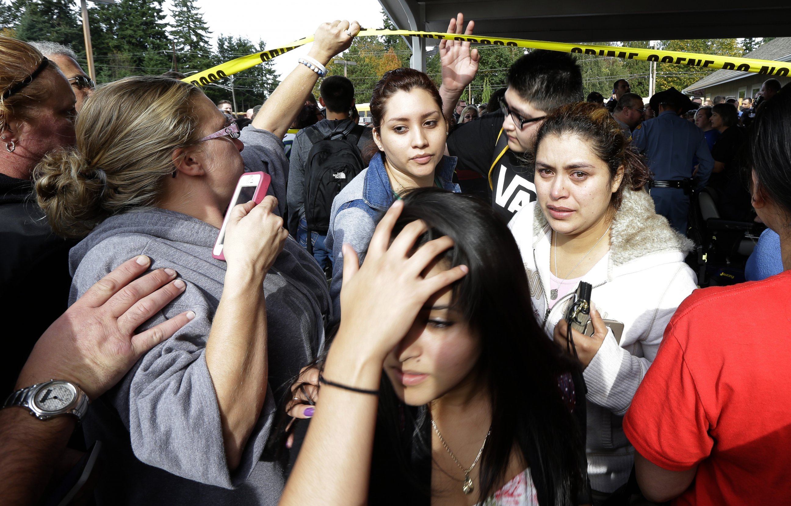 PHOTO: Parents and students move under police tape at a church, where students were taken following a shooting at Marysville Pilchuck High School in Marysville, Wash. on Oct. 24, 2014.