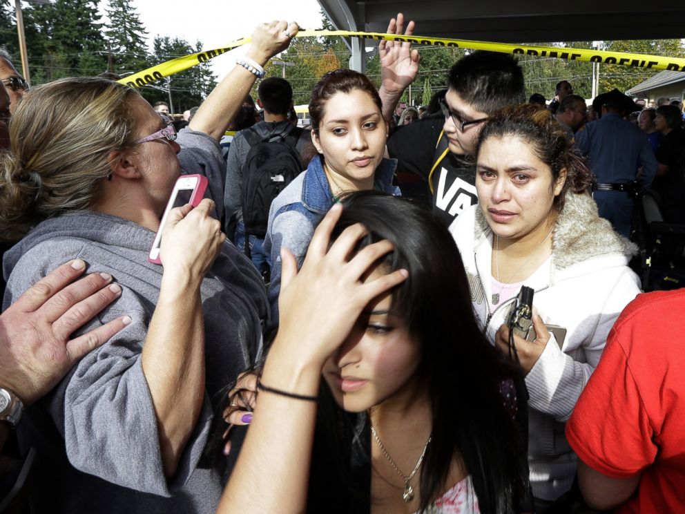 PHOTO: Parents and students move under police tape at a church, where students were taken following a shooting at Marysville Pilchuck High School in Marysville, Wash. on Oct. 24, 2014.