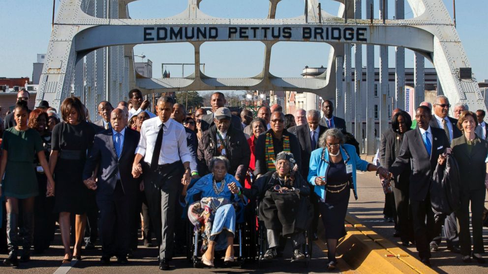 PHOTO: President Barack Obama, holding hands with Amelia Boynton, as they and the first family and others including Rep. John Lewis, D-Ga, left of Obama, walk across the Edmund Pettus Bridge in Selma, Ala. , Saturday, March 7, 2015.