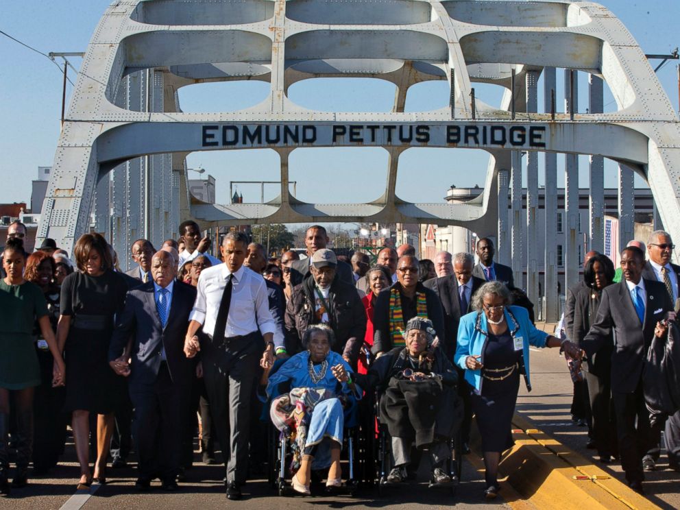 PHOTO: President Barack Obama, holding hands with Amelia Boynton, as they and the first family and others including Rep. John Lewis, D-Ga, left of Obama, walk across the Edmund Pettus Bridge in Selma, Ala. , Saturday, March 7, 2015.