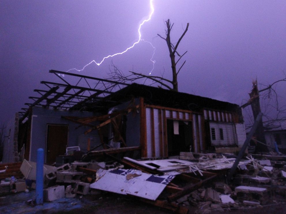 PHOTO: Lightning illuminates a house after a tornado touched down in Jefferson County, Ala., damaging several houses, Friday, Dec. 25, 2015, in Birmingham, Ala. A Christmastime wave of severe weather continued Friday.