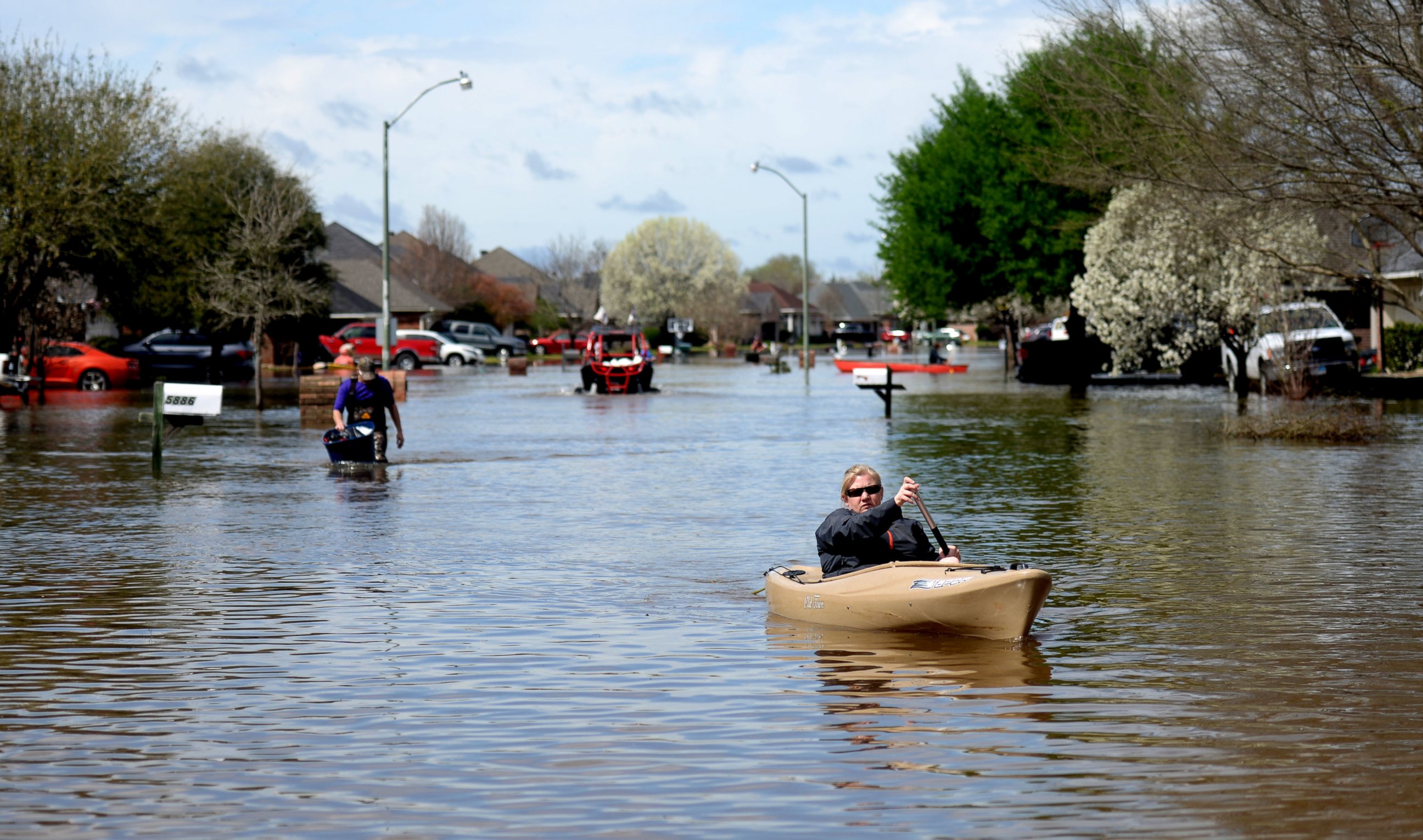 Golden Meadows resident Sabrina Langley canoes to the road to leave the flooded subdivision in Bossier Parish, La., March 10, 2016.