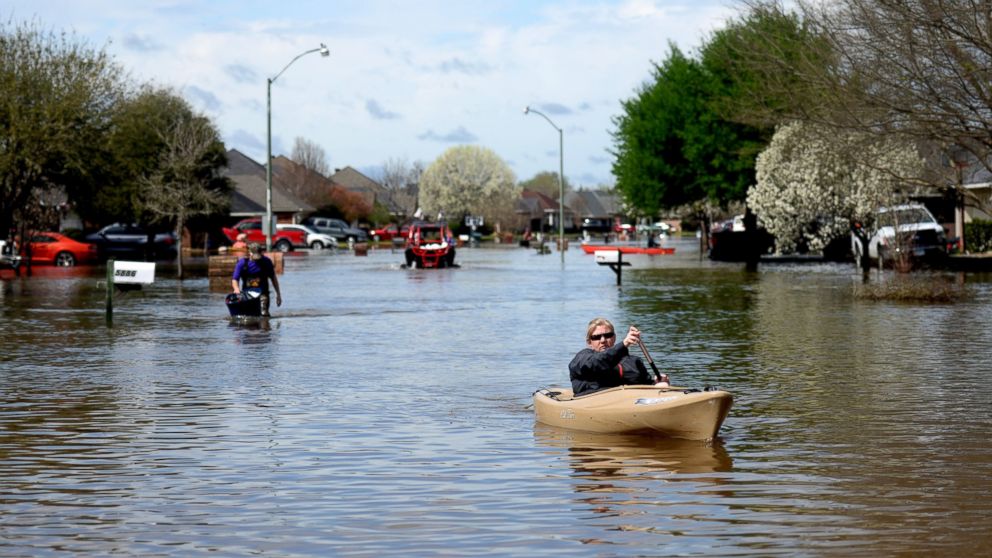 Golden Meadows resident Sabrina Langley canoes to the road to leave the flooded subdivision in Bossier Parish, La., March 10, 2016.