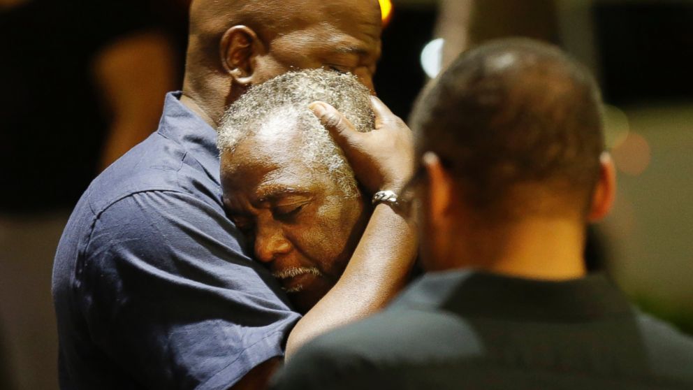 Worshippers embrace following a group prayer across the street from the scene of a shooting at Emanuel AME Church,  June 17, 2015, in Charleston, S.C.