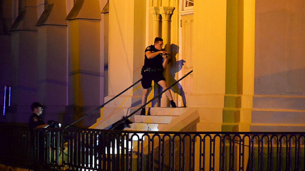 Charleston police officers search for a shooting suspect outside the Emanuel AME Church, in downtown Charleston, S.C., June 17, 2015. 
