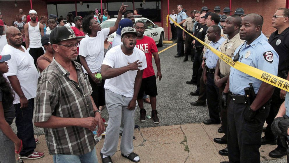 PHOTO: A crowd is stopped by police as they were trying to reach the scene where 18-year-old Michael Brown was fatally shot by police in Ferguson, Mo., near St. Louis on Saturday, Aug. 9, 2014.