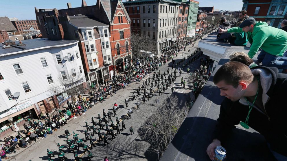 People watch the annual St. Patrick's Day parade from a roof in the South Boston neighborhood of Boston, March 16, 2014.