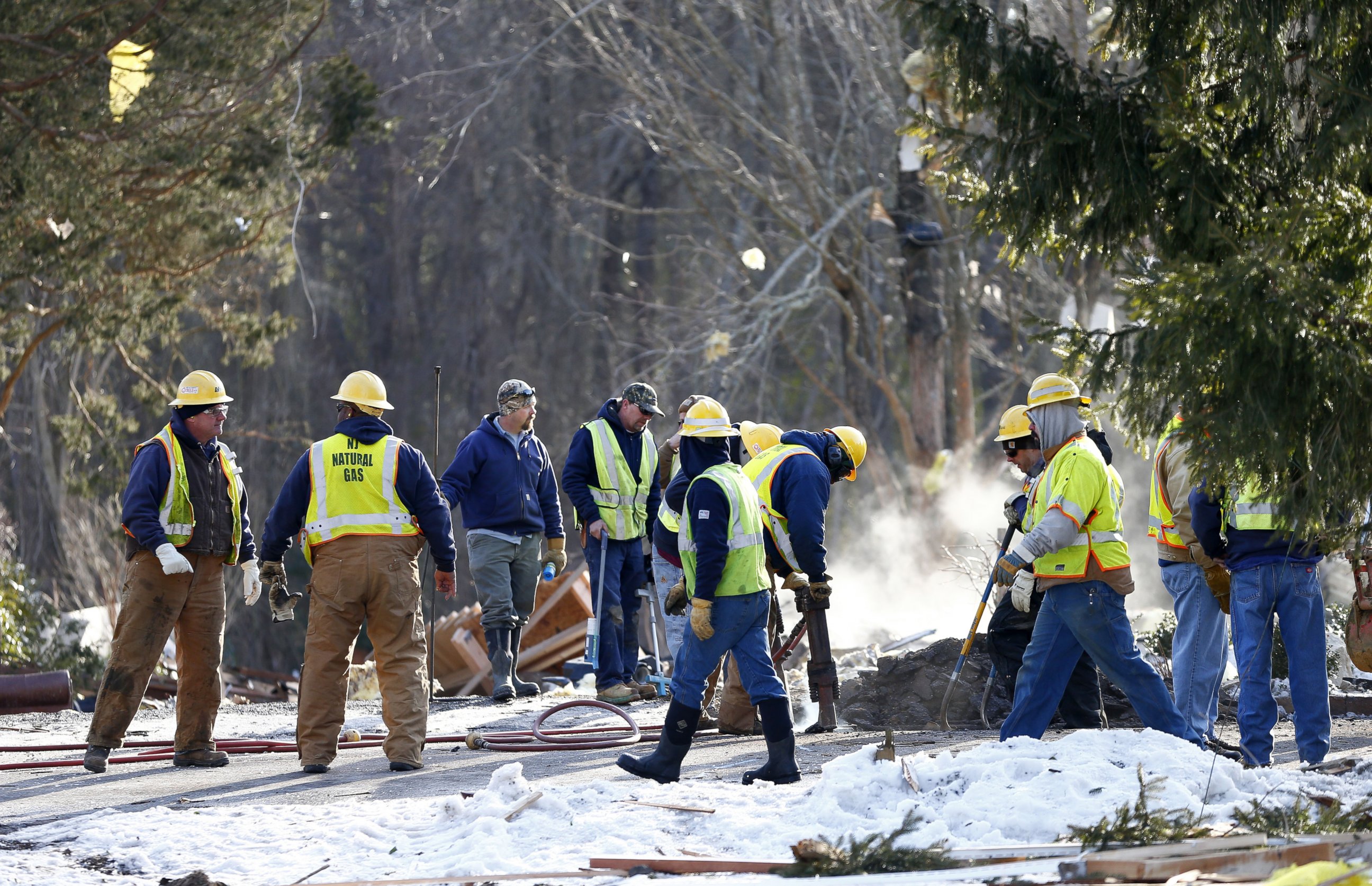 PHOTO: NJ Natural Gas personnel dig in front of smoldering debris after a natural gas explosion leveled a house in Stafford, N.J., Feb. 24, 2015.