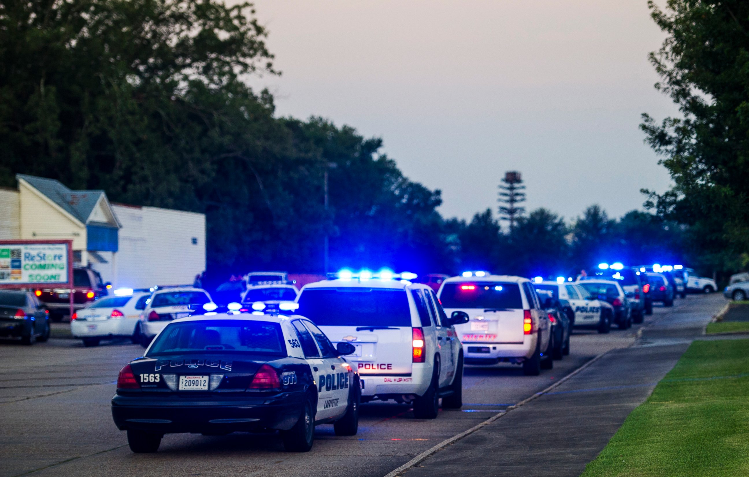 PHOTO: Lafayette Police Department and Louisiana State Police units block an entrance road following a shooting at The Grand Theatre in Lafayette, La., Thursday, July 23, 2015.