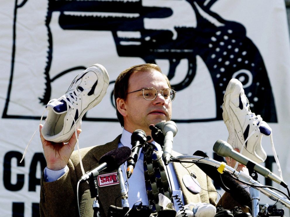 PHOTO: Tom Mauser holds up a pair of shoes belonging to his late son, Daniel, who was killed in the Columbine High School shooting, during a rally at the Capitol in Denver, April 11, 2000.