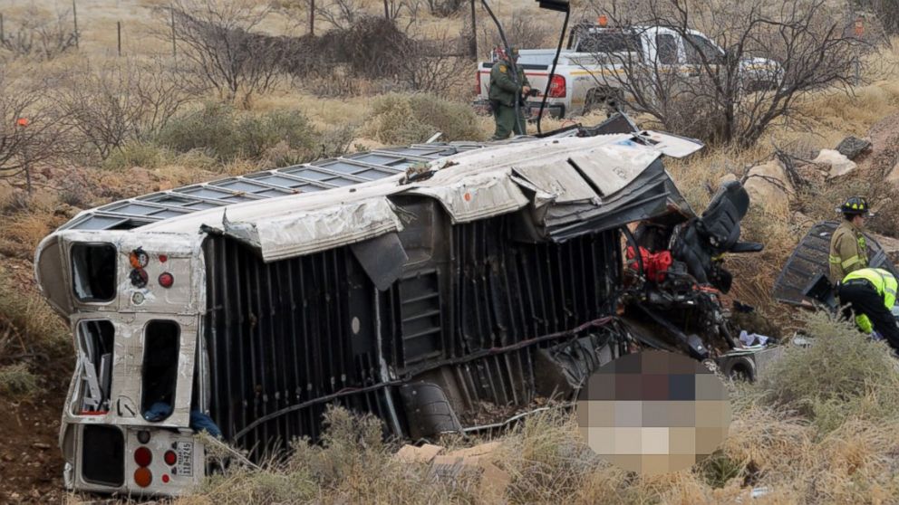 Officials investigate the scene of a prison transport bus crash in Penwell, Texas, Jan. 14, 2015.