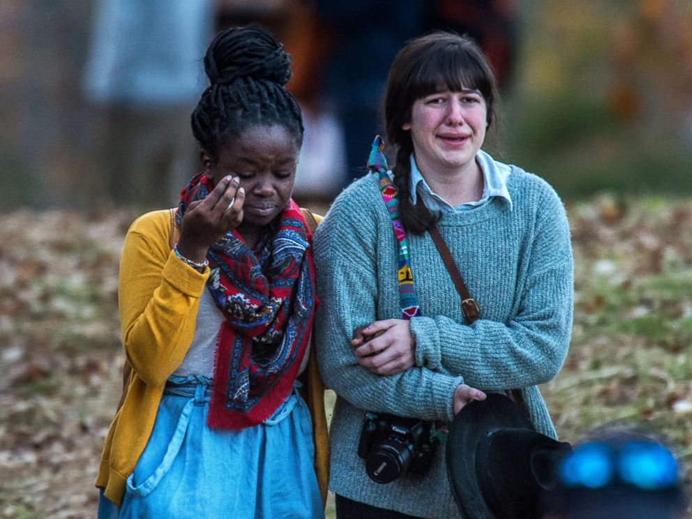 PHOTO: Girls console each other as they walk away from the scene of the accident where one of their friends allegedly fell off the train trestle which crossed the James River at Riverside Park, Nov. 8, 2014. 