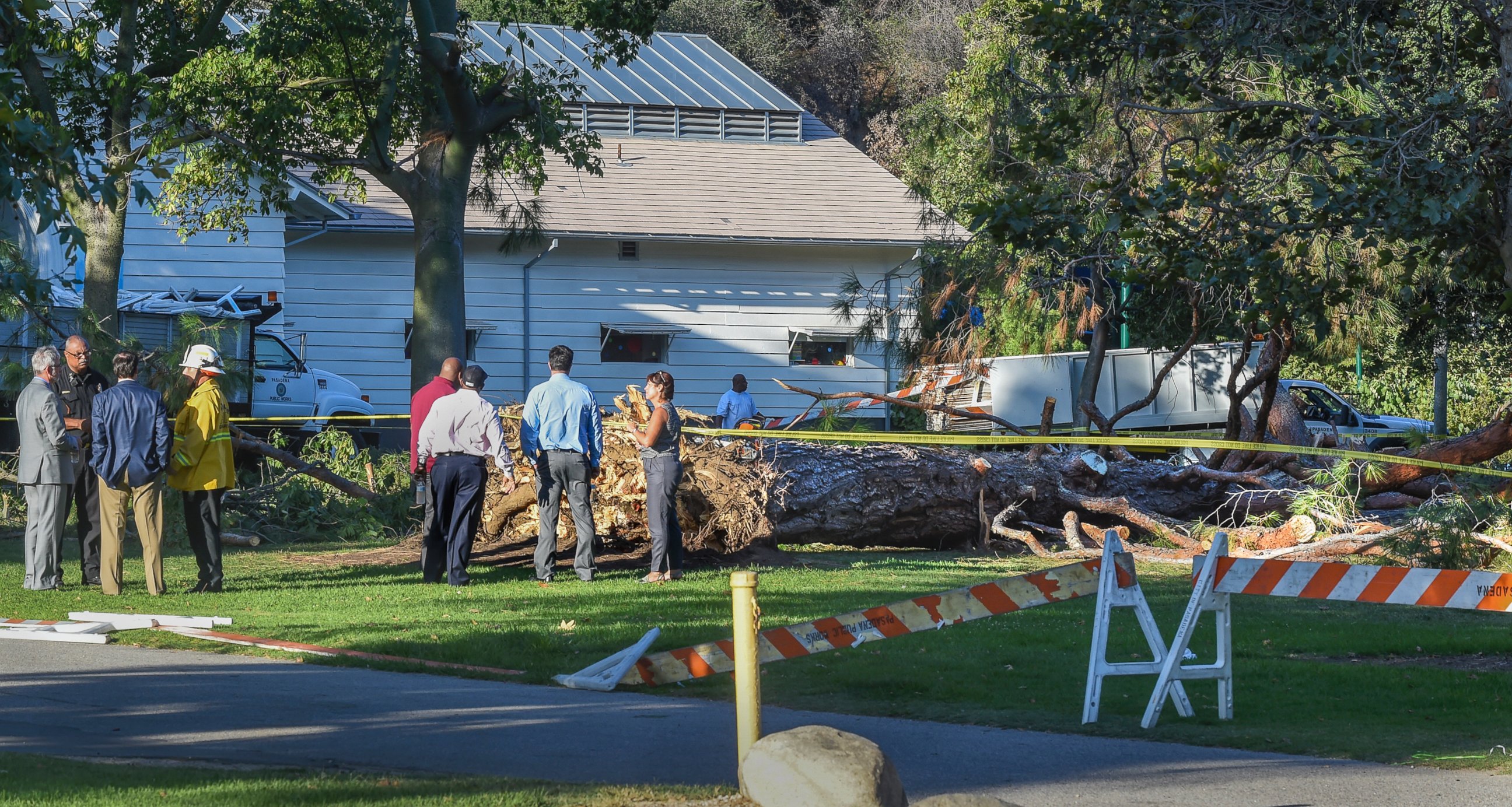 PHOTO: Officials stand by a tree that fell near the Kidspace Children's Museum in Pasadena, Calif., Tuesday, July 28, 2015. Witnesses say the tree came down on children just as a summer day camp at the museum was letting out for the day.