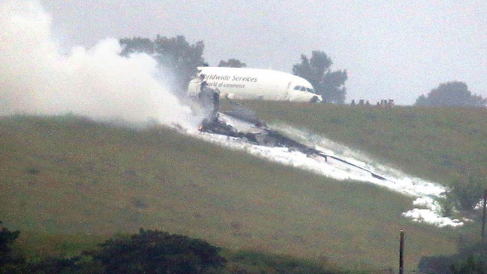 A UPS cargo plane lies on a hill at Birmingham-Shuttlesworth International Airport after crashing on approach, Aug. 14,  2013, in Birmingham, Ala. 