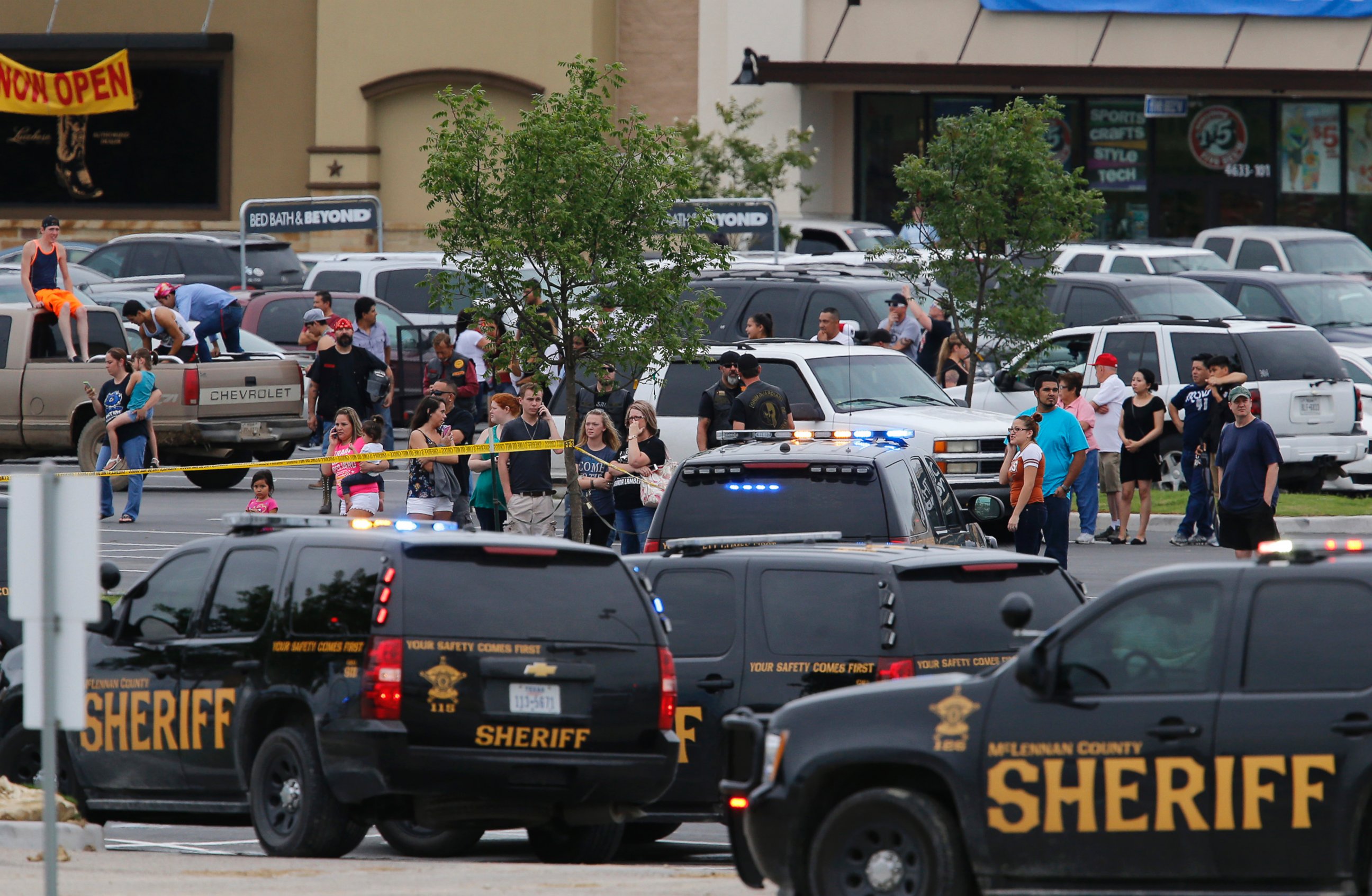 PHOTO: People at the Central Texas MarketPlace watch a crime scene near the parking lot of a Twin Peaks restaurant Sunday, May 17, 2015, in Waco, Texas. 