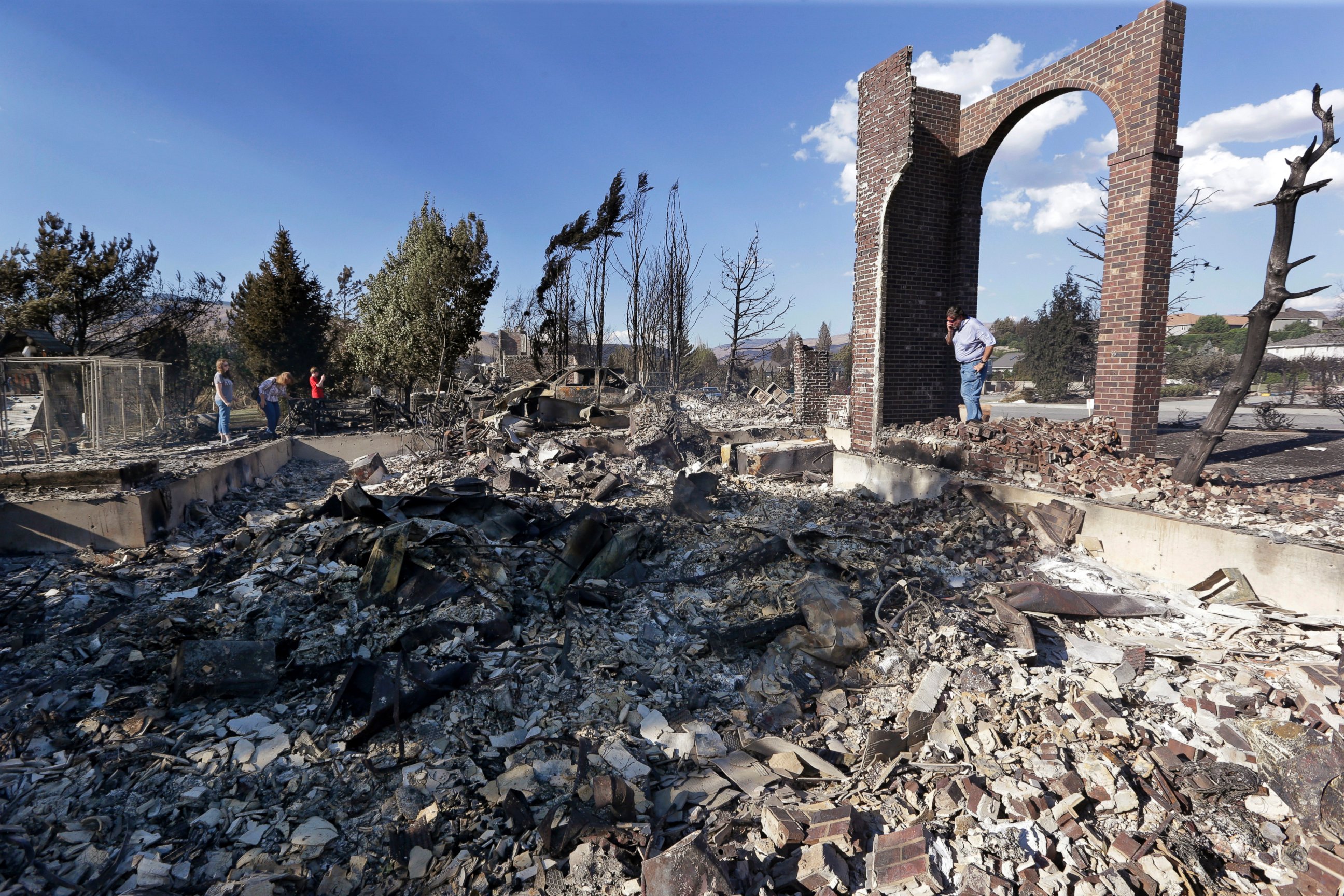 PHOTO: A man stands in front of the remains of his fire-destroyed home, June 29, 2015, in Wenatchee, Wash. 