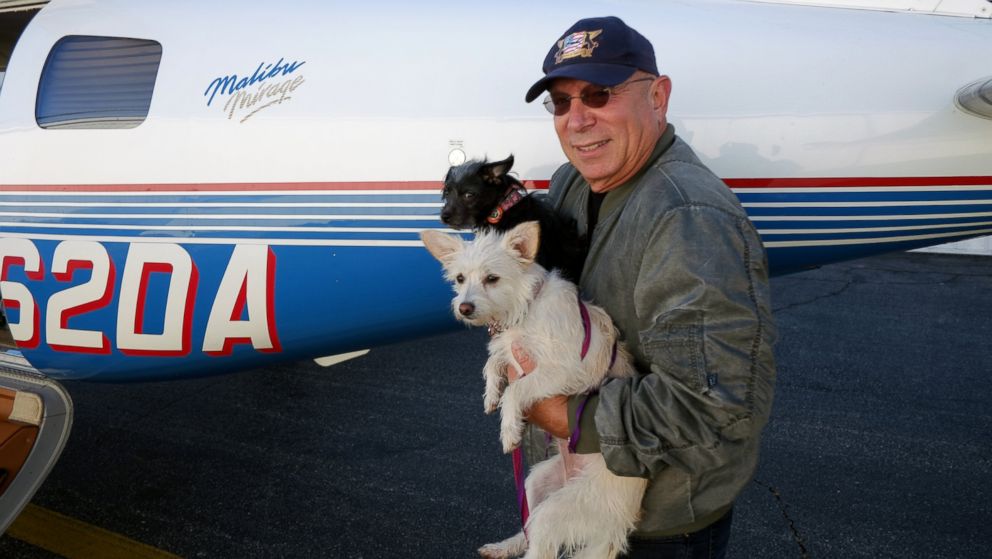 PHOTO: Yahuda Netanel, prepares to board his plane with two rescue dogs prior to a flight out of the Van Nuys Airport, in Van Nuys, Calif., April 8, 2015. 