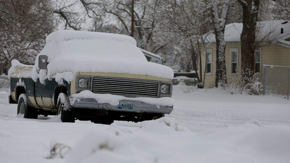 A pickup sits covered in snow Tuesday, March 3, 2015 on East M Street in north Casper, Wyo. 