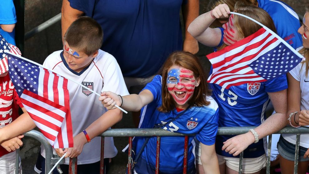 PHOTO: A young fan cheers while waiting for the ticker tape parade to celebrate the U.S. women's soccer team World Cup victory, July 10, 2015, in New York.