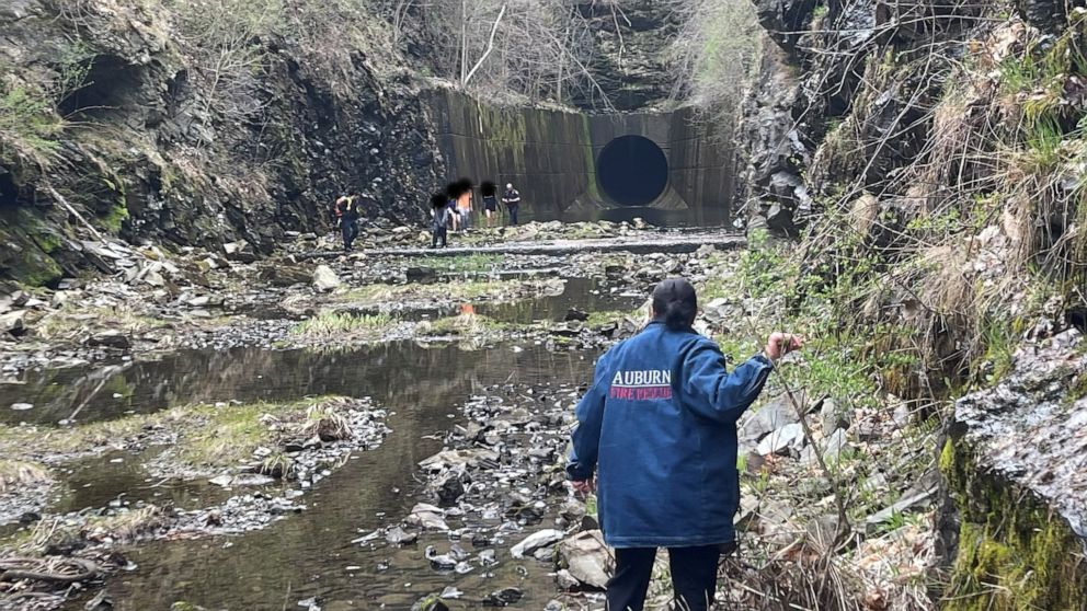 PHOTO: Members of the Auburn Fire Department help rescue teenagers near a diversion water tunnel in Auburn, Massachusetts, on March 16, 2023.