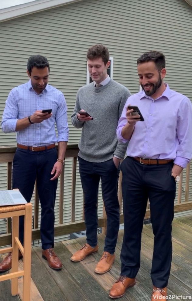 PHOTO: Dr. Kapoor and two other students take their Hippocratic Oath using their cellphones after graduating from UMass Medical School.