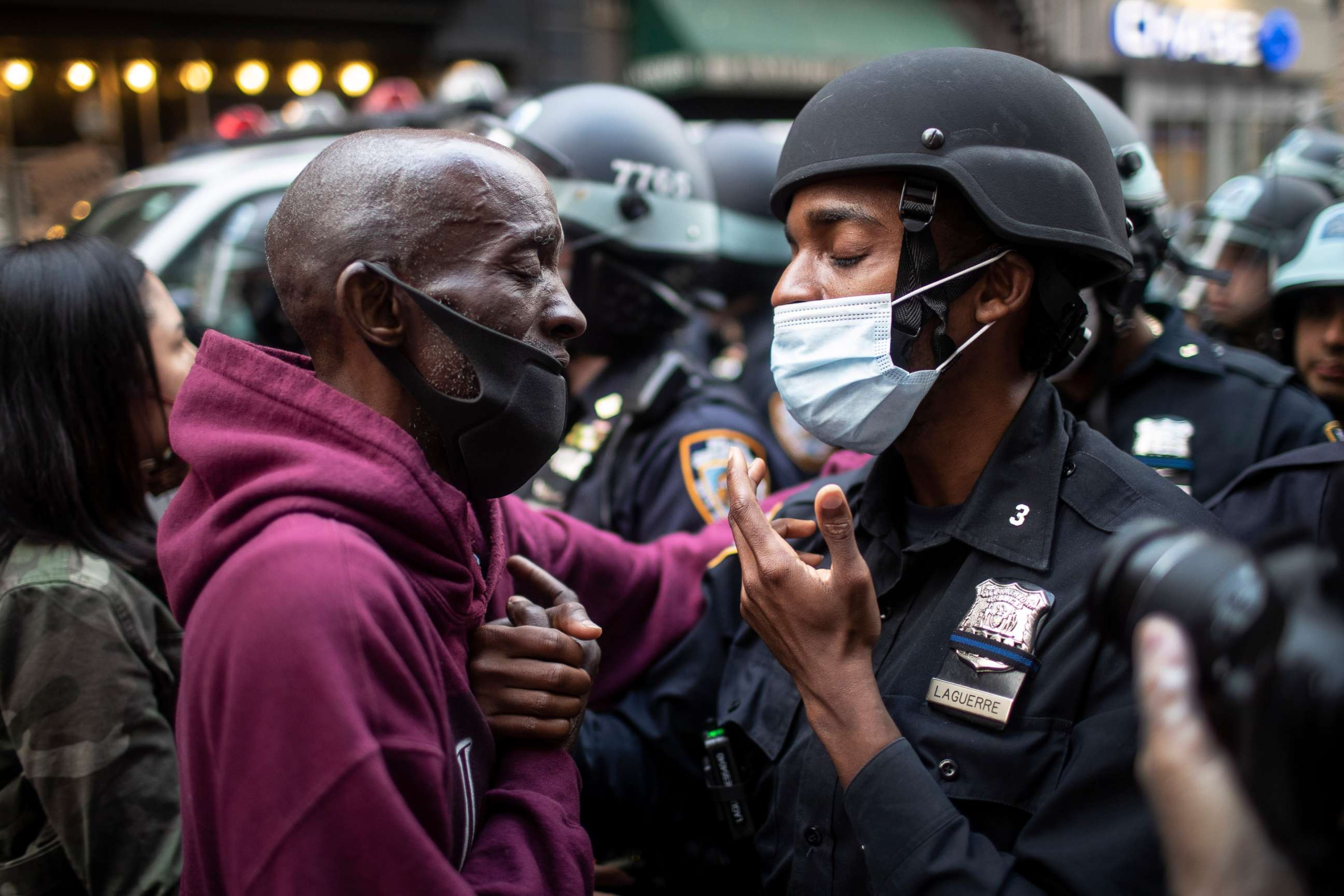 PHOTO: A protester and an officer shake hands in the middle of a standoff during a rally calling for justice over the death of George Floyd Tuesday, June 2, 2020, in New York. Floyd died after being restrained by Minneapolis police officers on May 25.