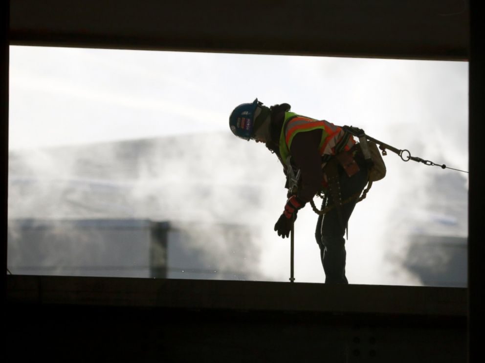 A worker braves cold temperatures while working atop steel beams at the Albany convention center project on Feb. 12, 2016, in Albany, N.Y. 