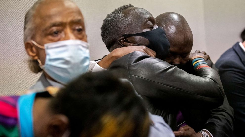 PHOTO: Ahmaud Arbery's father Marcus Arbery, center, his hugged by his attorney Benjamin Crump after the jury convicted Travis McMichael in the Glynn County Courthouse, Nov. 24, 2021, in Brunswick, Ga.  