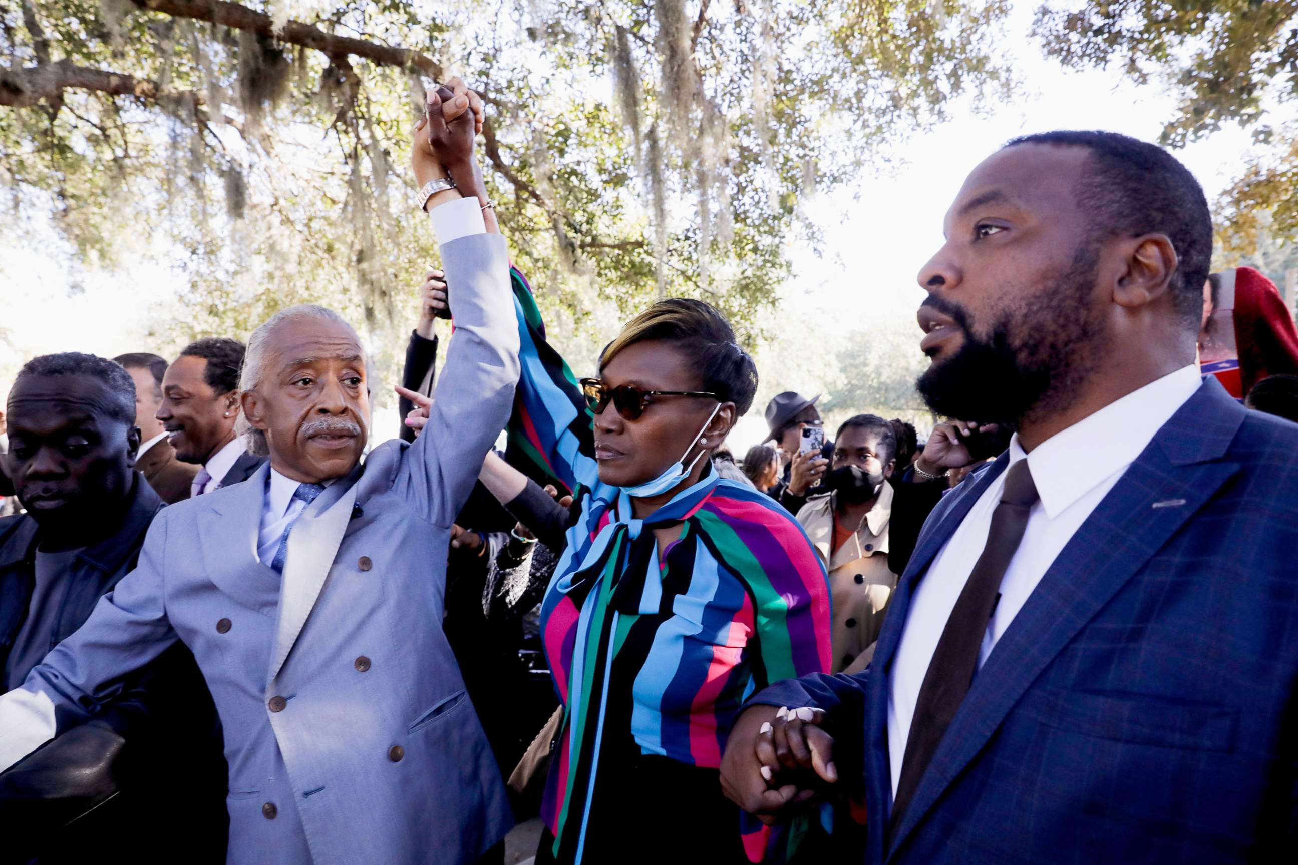 PHOTO: Rev. Al Sharpton and Wanda Cooper-Jones, mother of Ahmaud Arbery, raise their hands outside the Glynn County Courthouse after the jury reached a guilty verdict in the trial of the death of Ahmaud Arbery, in Brunswick, Ga., Nov. 24, 2021. 