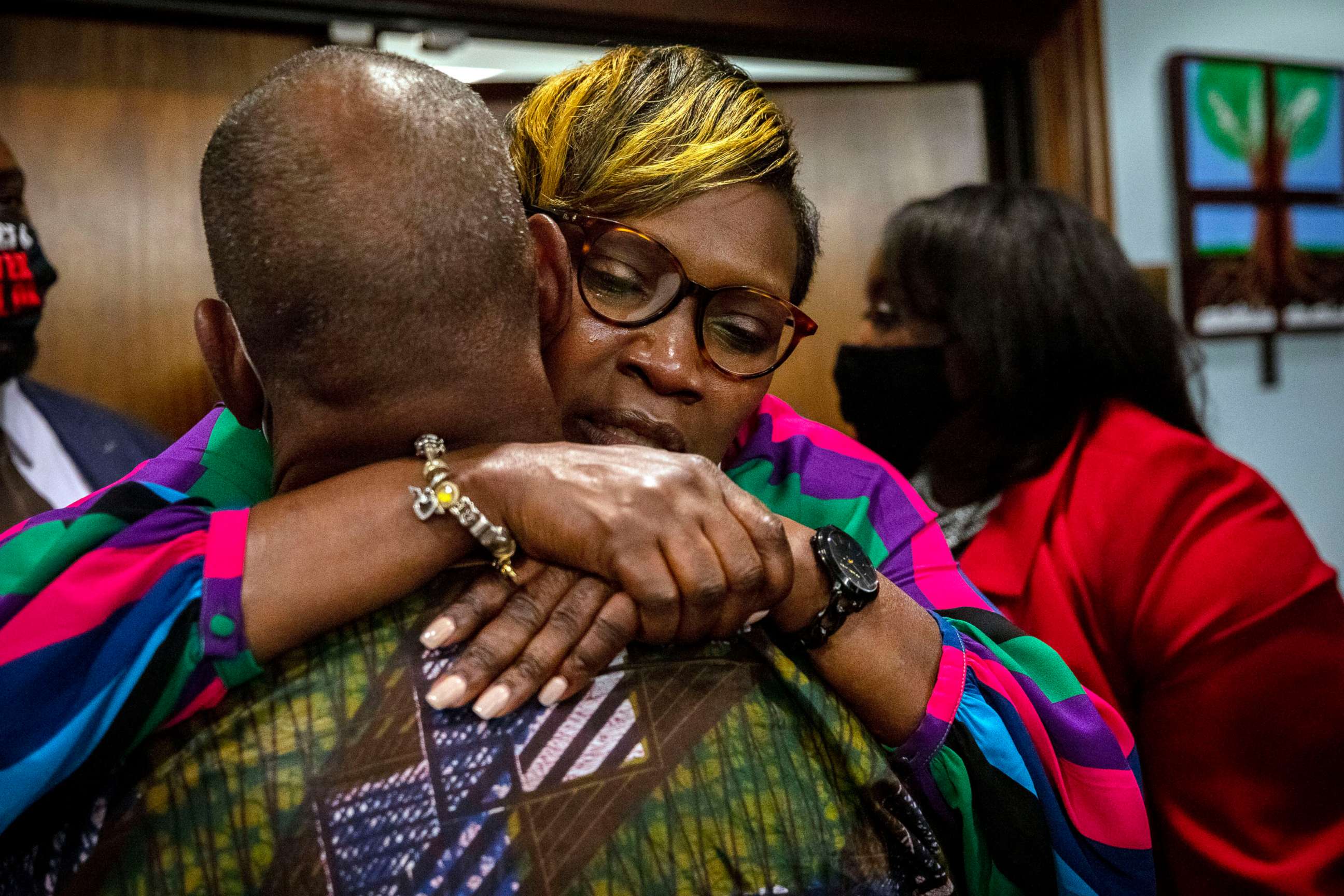 PHOTO: Ahmaud Arbery's mother, Wanda Cooper-Jones his hugged by a supporter after the jury convicted Travis McMichael in the trial of McMichael, his father, Greg McMichael, and neighbor, William "Roddie" Bryan, Nov. 24, 2021, in Brunswick, Ga.