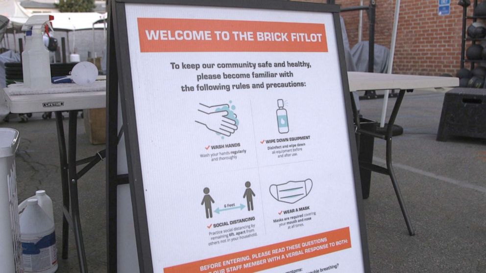 PHOTO: A sign at Brick Nation in Los Angeles offers guidance on COVID-19 safety measures. 