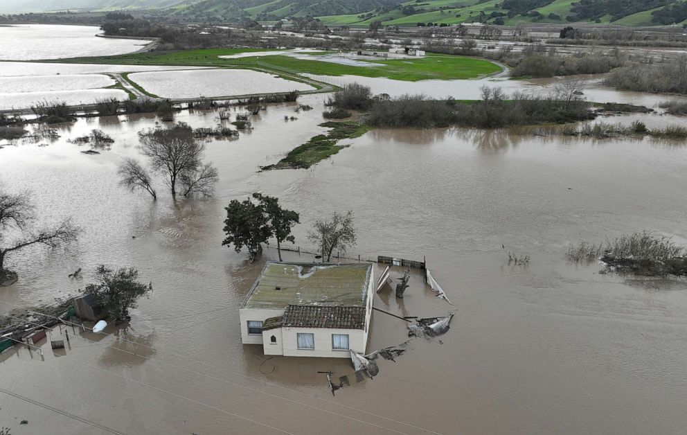 In an aerial view, a home is seen submerged in floodwater as the Salinas River begins to overflow its banks on January 13, 2023 in Salinas, California.