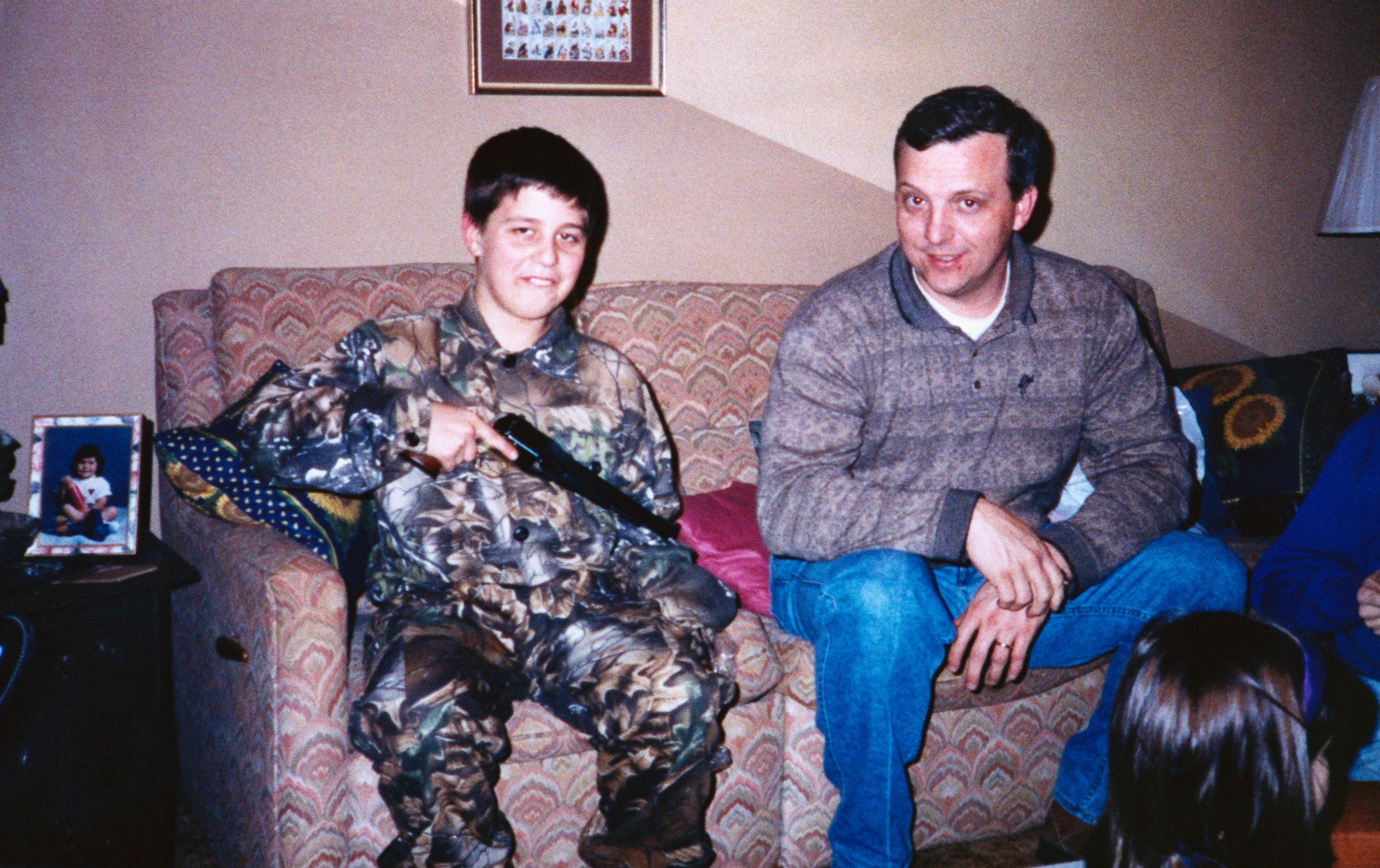 PHOTO: In a family photo, Andrew Golden holds a handgun as he sits in the living room with his father. Andrew is one of two boys accused in the shooting deaths of four girls and one teacher at the Westside Middle School, March 24, 1998. 