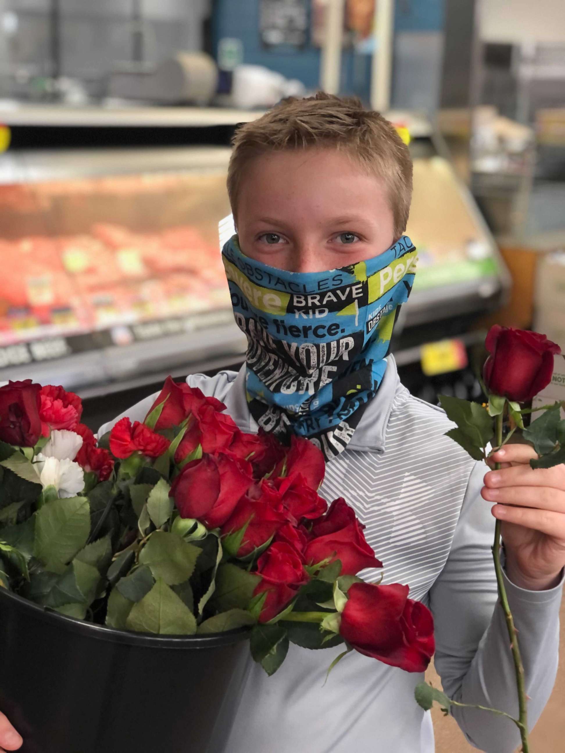 11-year-old JJ Witmer handing out flowers to King Soopers employees at the scene of this weeks fatal shootings