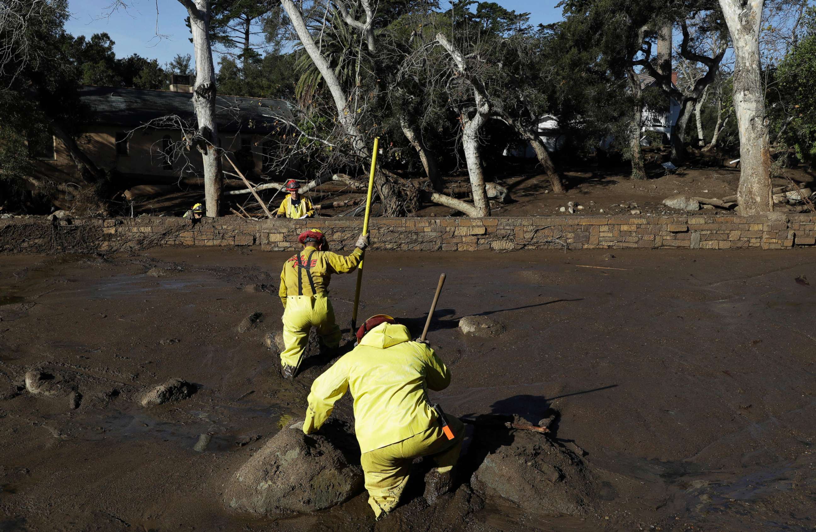 PHOTO: A Cal Fire search and rescue crew walks through mud near homes damaged by storms in Montecito, Calif., Jan. 12, 2018. The mudslide, touched off by heavy rain, took many homeowners by surprise early despite warnings issued days in advance.
