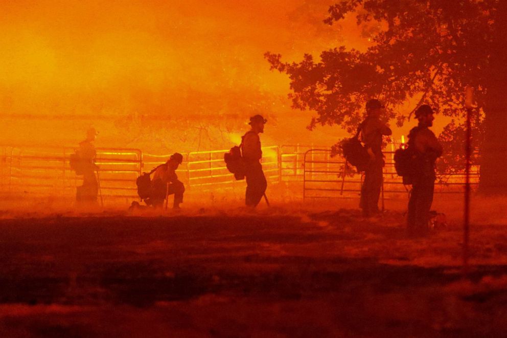 PHOTO: Firefighters look on as the Oak Fire burns in Darrah, in Mariposa County, Calif., July 22, 2022. 