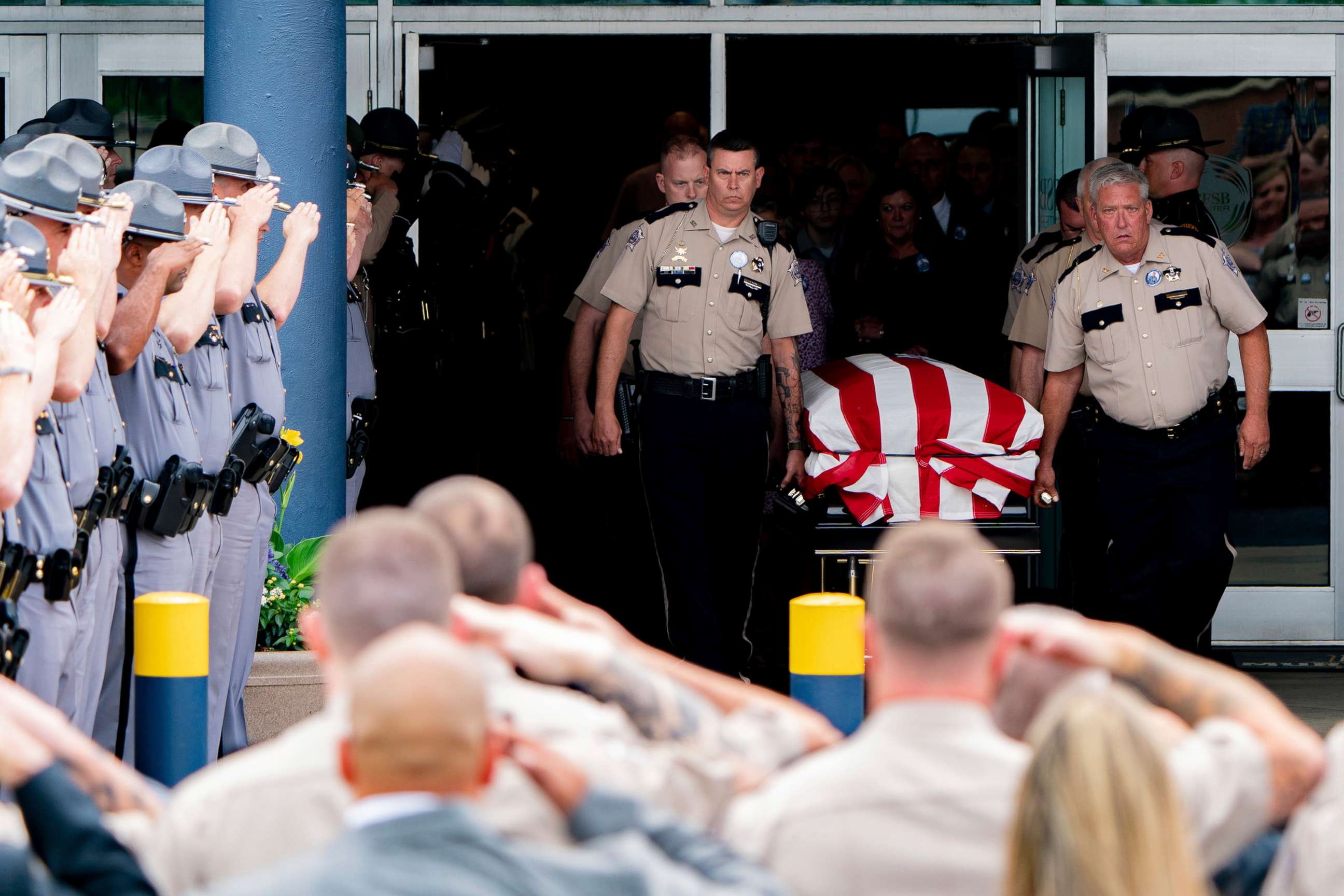 PHOTO: Law enforcement officers salute as Calloway County officers carry the casket of fallen Calloway County Deputy Jody Cash following Cash's memorial service in Murray, Ky., May 21, 2022.
