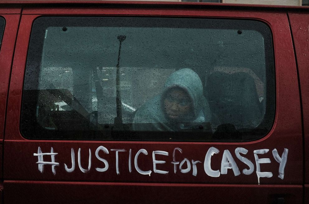 PHOTO: COLUMBUS, OH - DECEMBER 12: A protester riding in a van watches as hundreds of protesters march through downtown Columbus on December 12, 2020 in Columbus, Ohio.